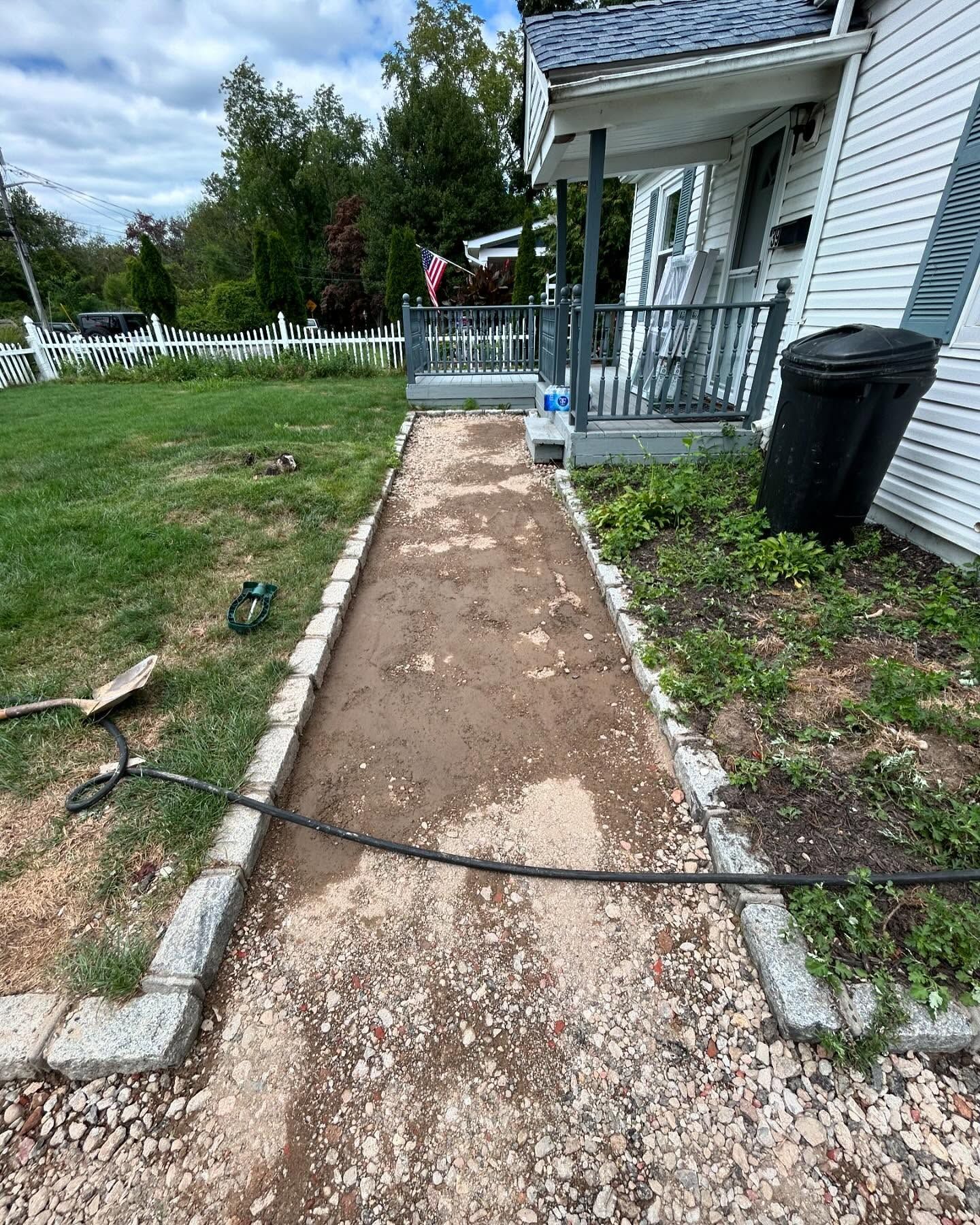 A sidewalk is being built in front of a house.