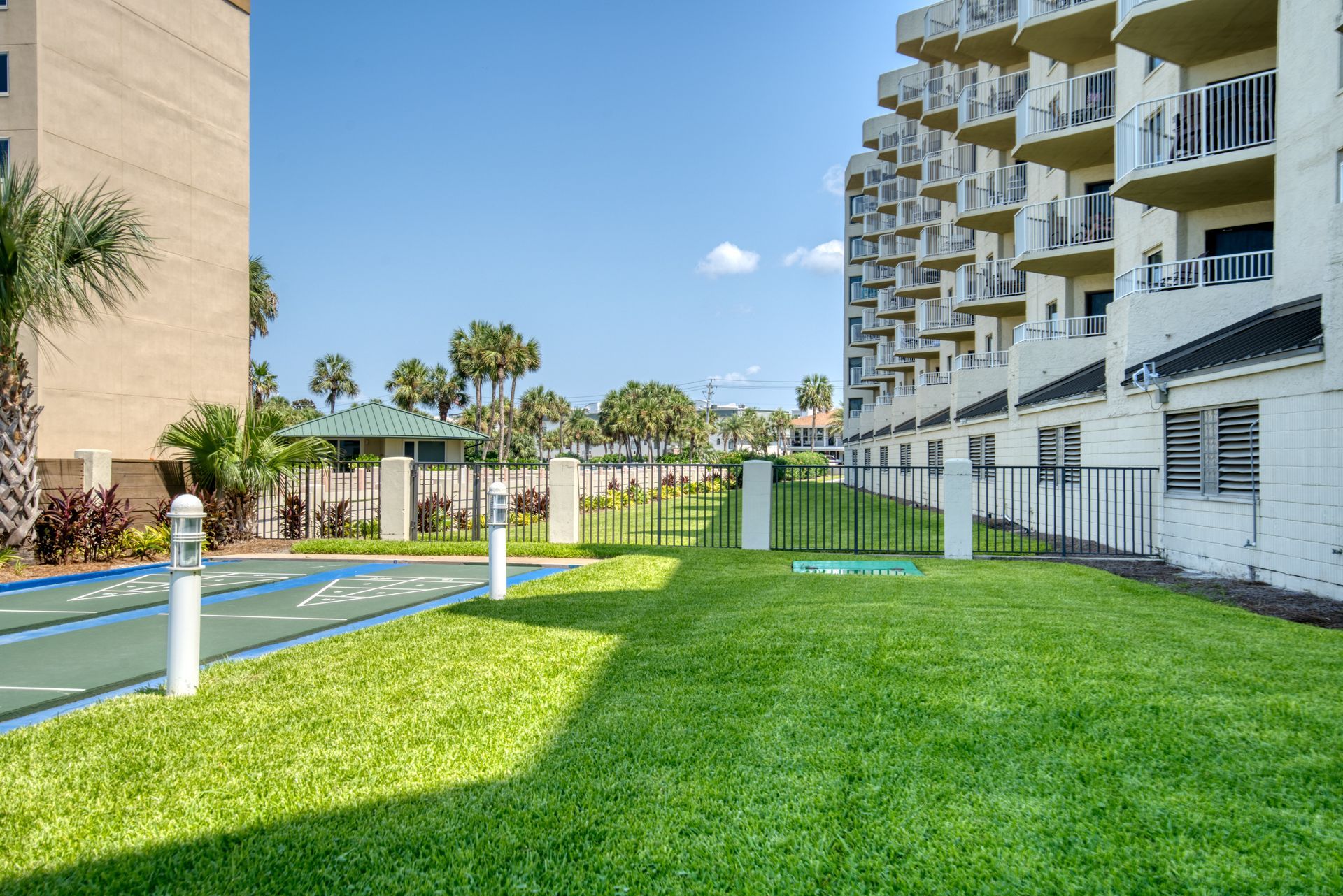 A large building with a basketball court in front of it.