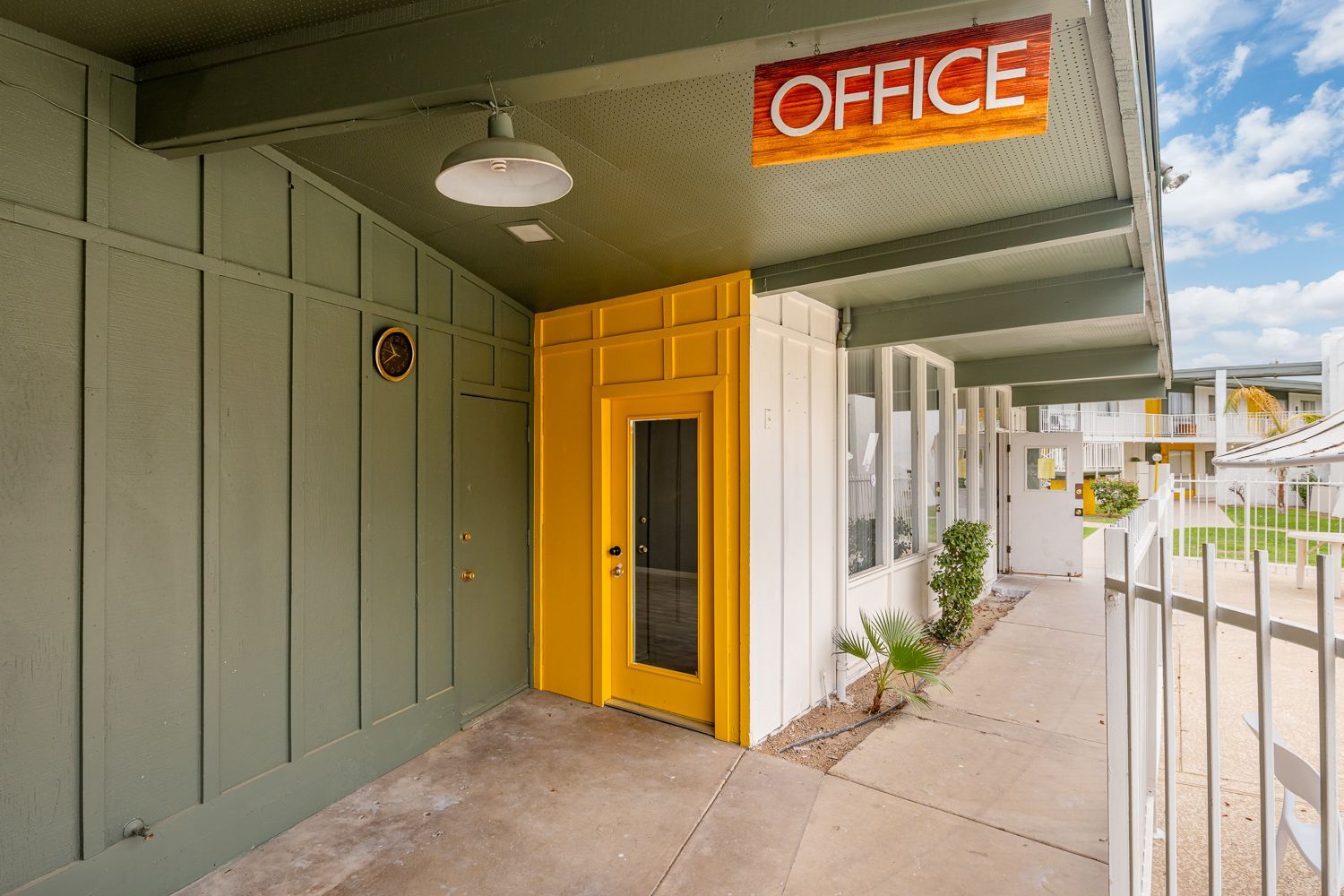 a building with a yellow door and a sign that says office