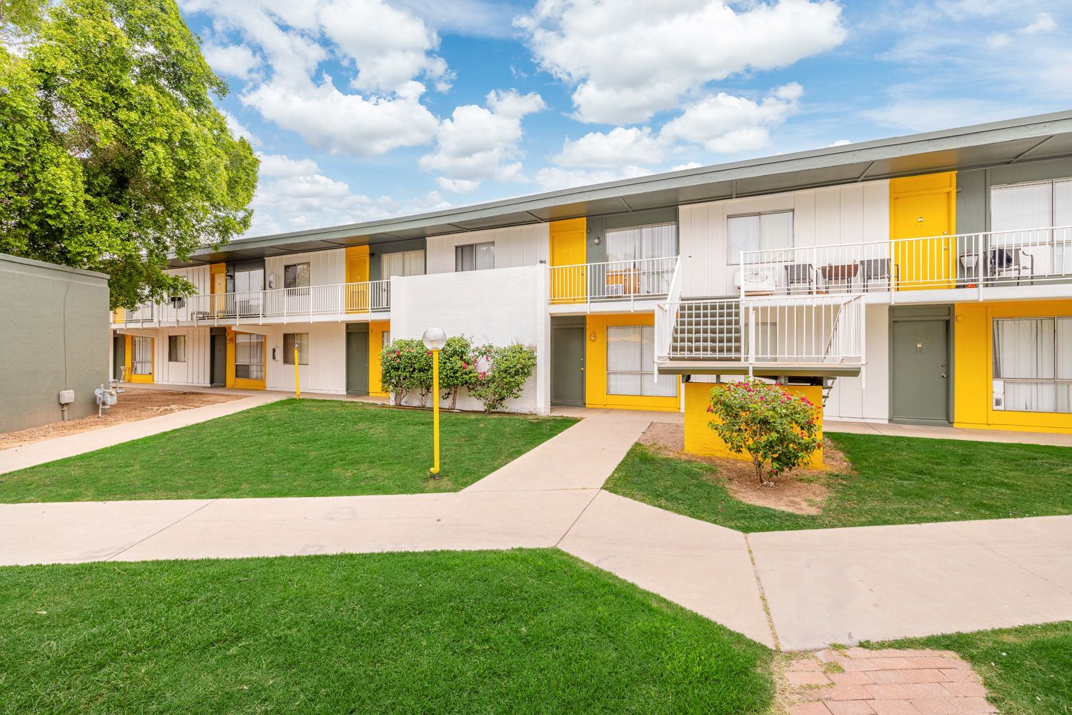 a large apartment building with stairs leading up to the second floor