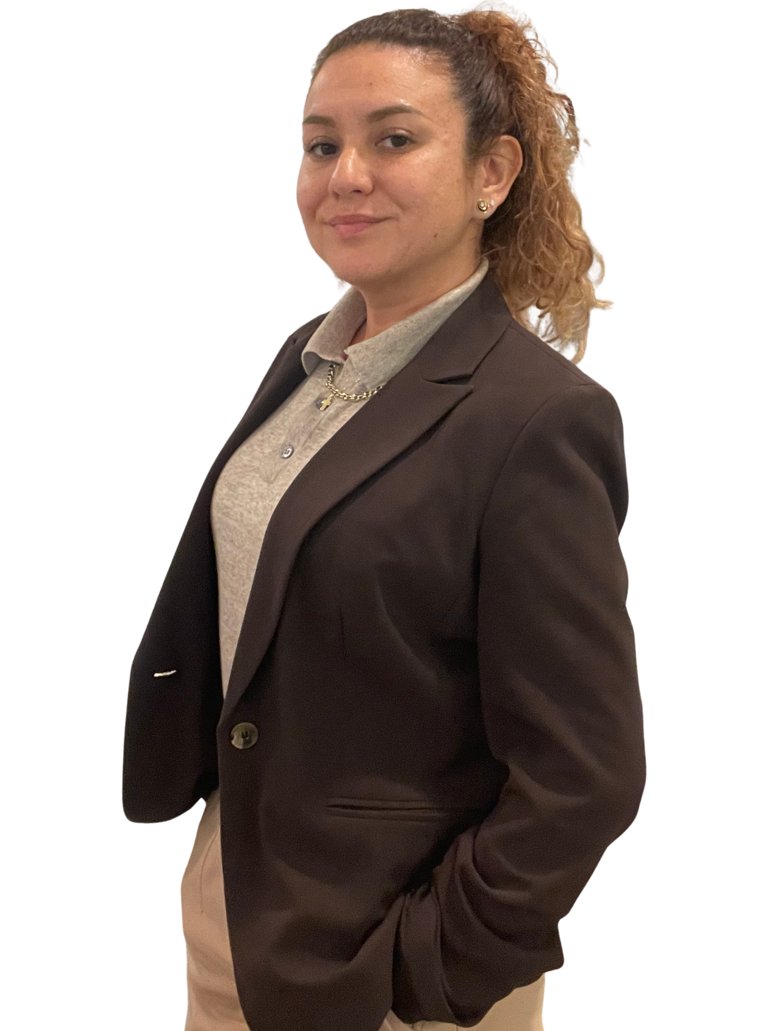 Person working at a wooden desk with plants, books, and a vase. A white chair and stool.