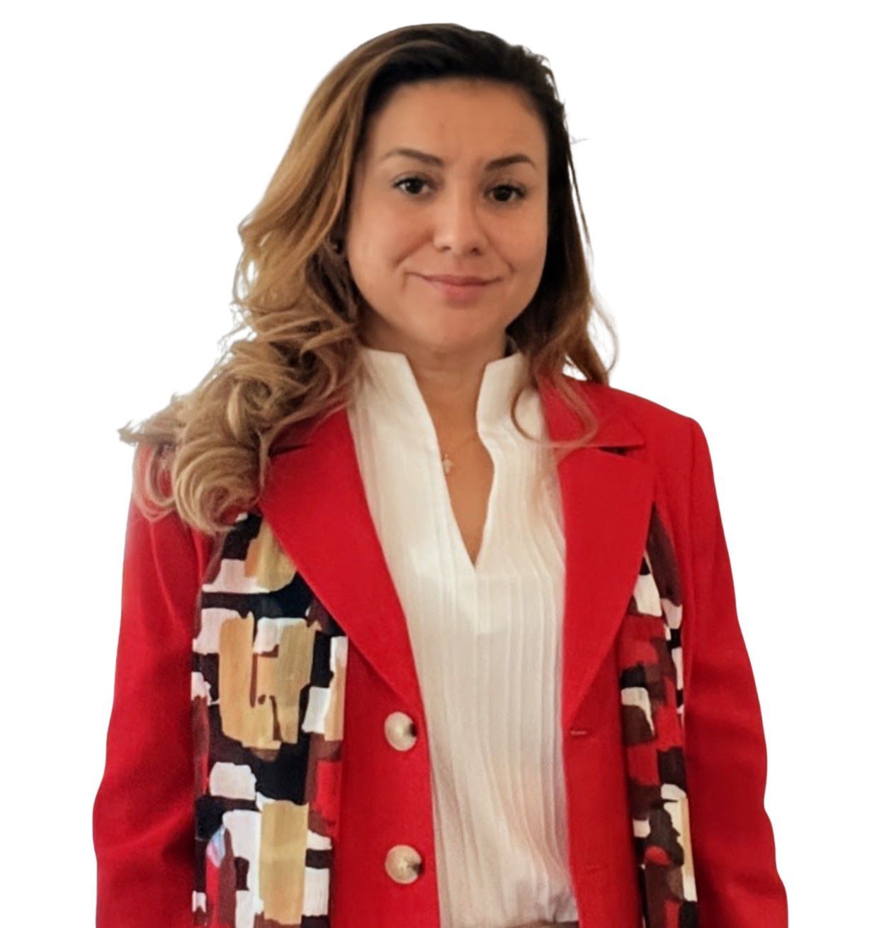Woman in a brown blazer and tan pants, smiling, with one hand in her pocket.
