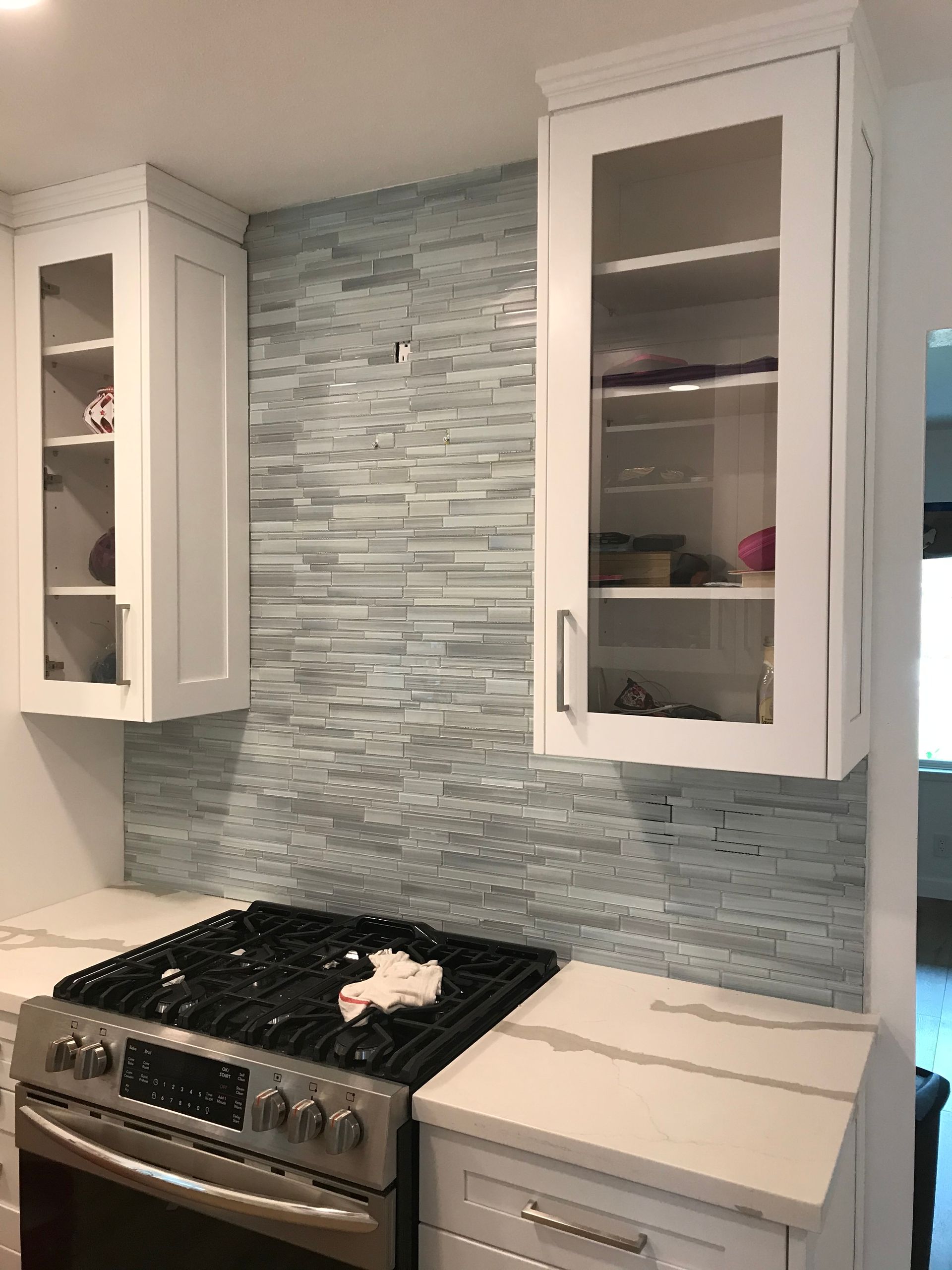 A kitchen with a stove , oven , and cabinets.