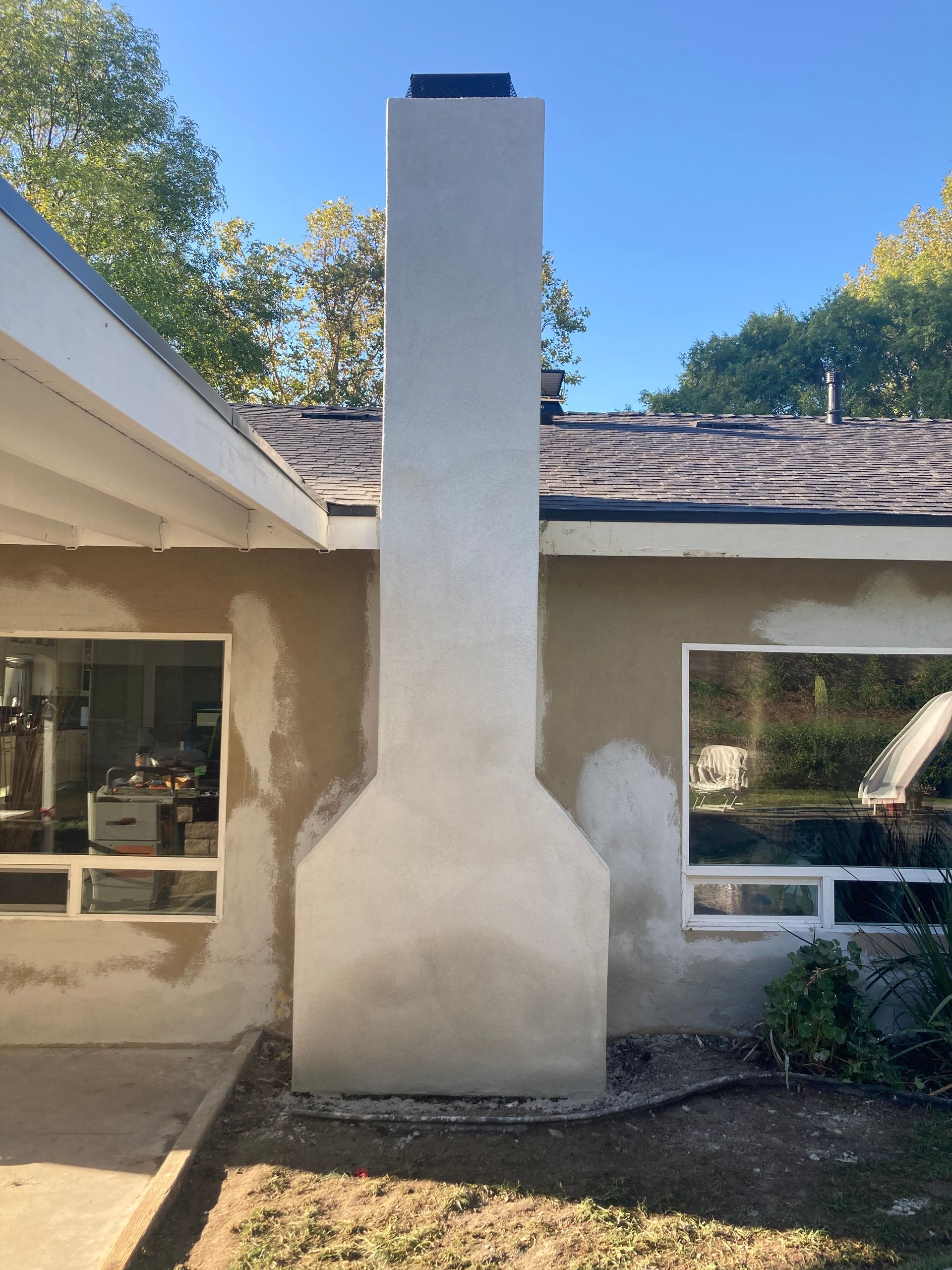 A large chimney on the side of a house
