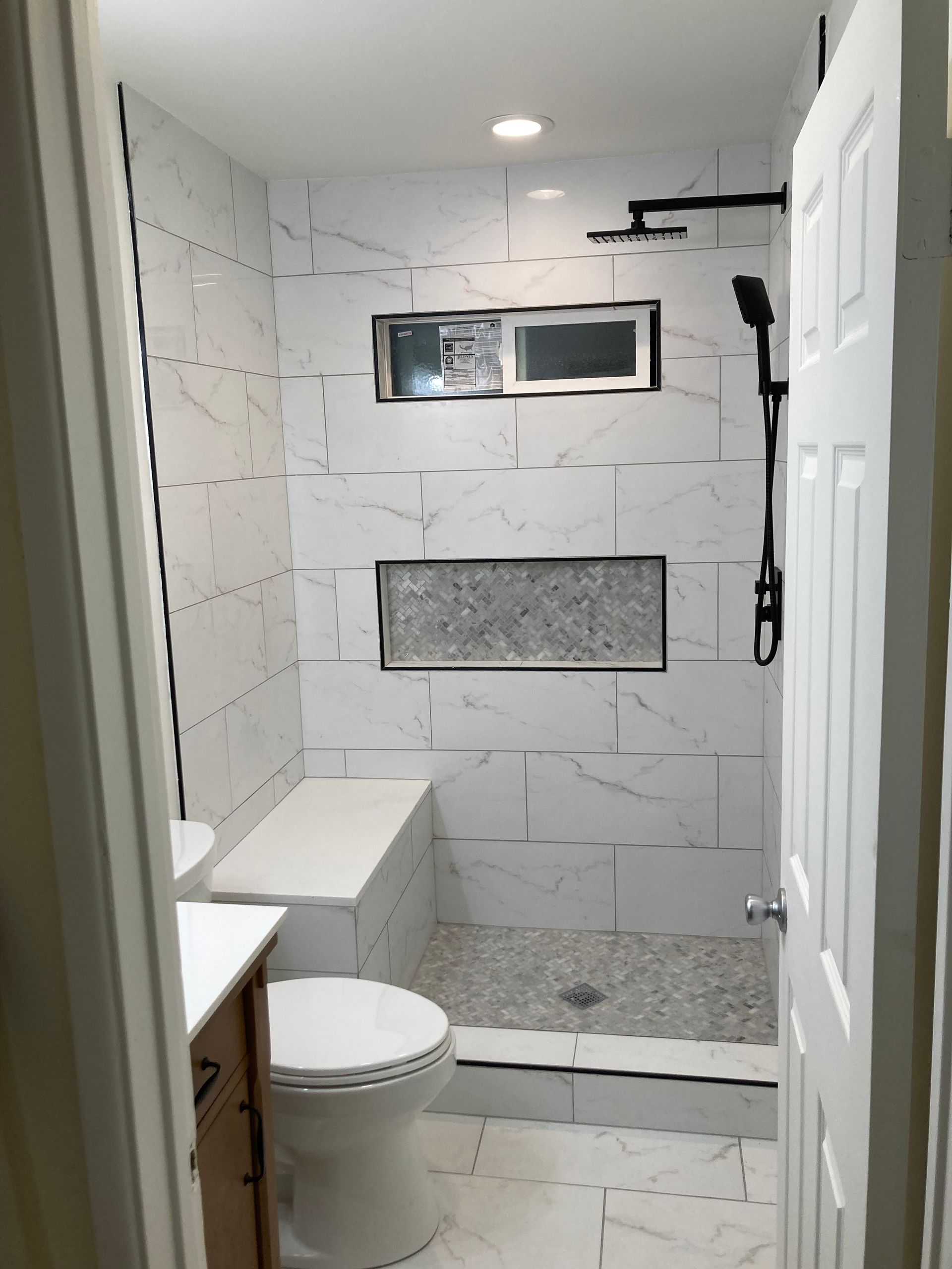 A bathroom with a bathtub , toilet , sink and shower.