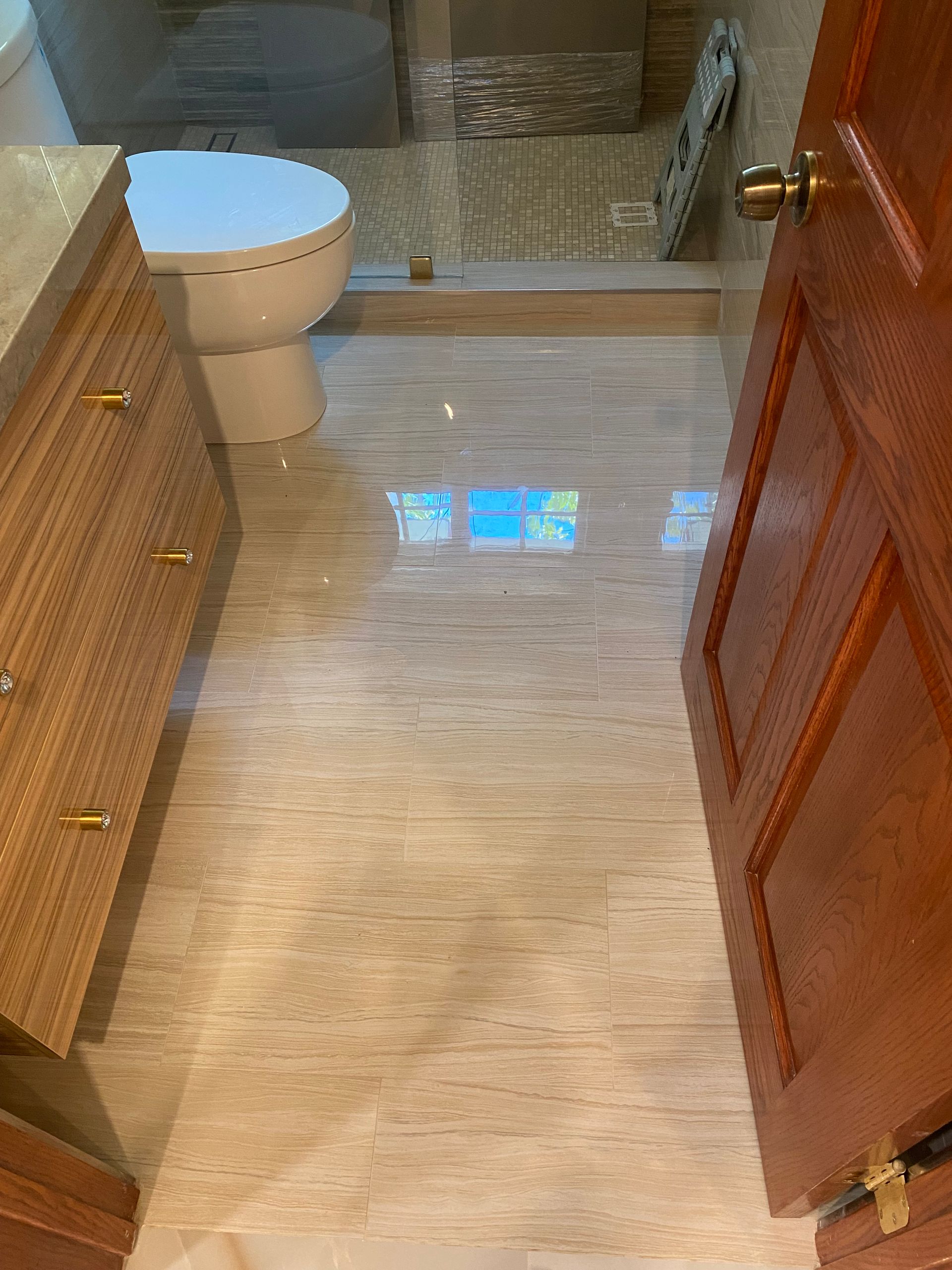 A bathroom with a toilet , sink , and shower.