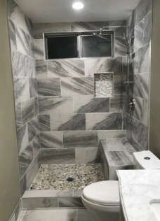 A bathroom with a walk in shower and a toilet.