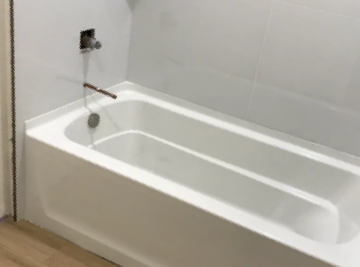 A white bathtub is sitting in a bathroom next to a door.