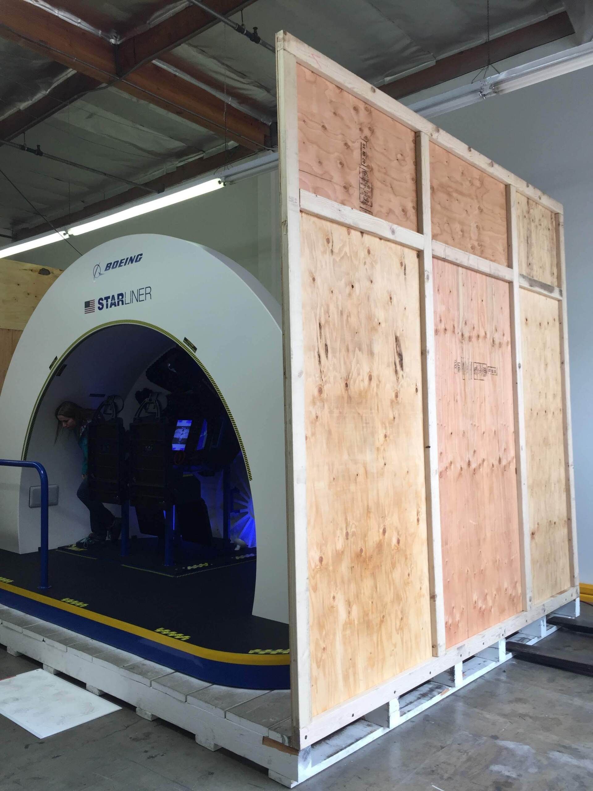 Medical scanner inside a wooden crate on a pallet.