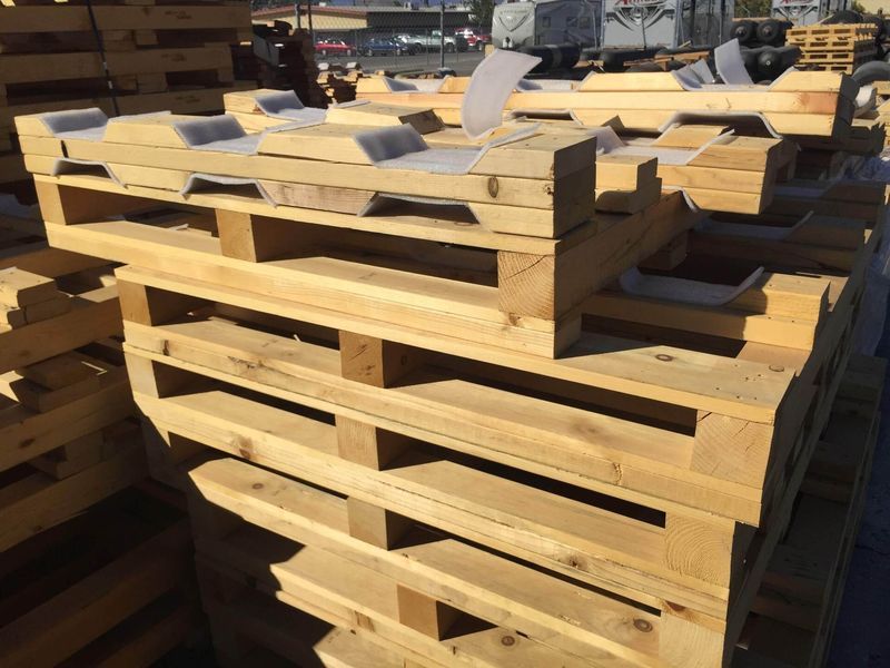 Stack of wooden pallets outdoors in daylight.