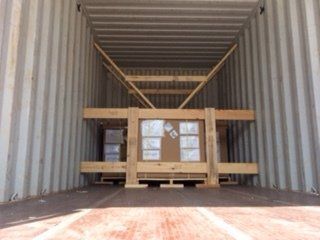 Wooden crate secured inside a shipping container.