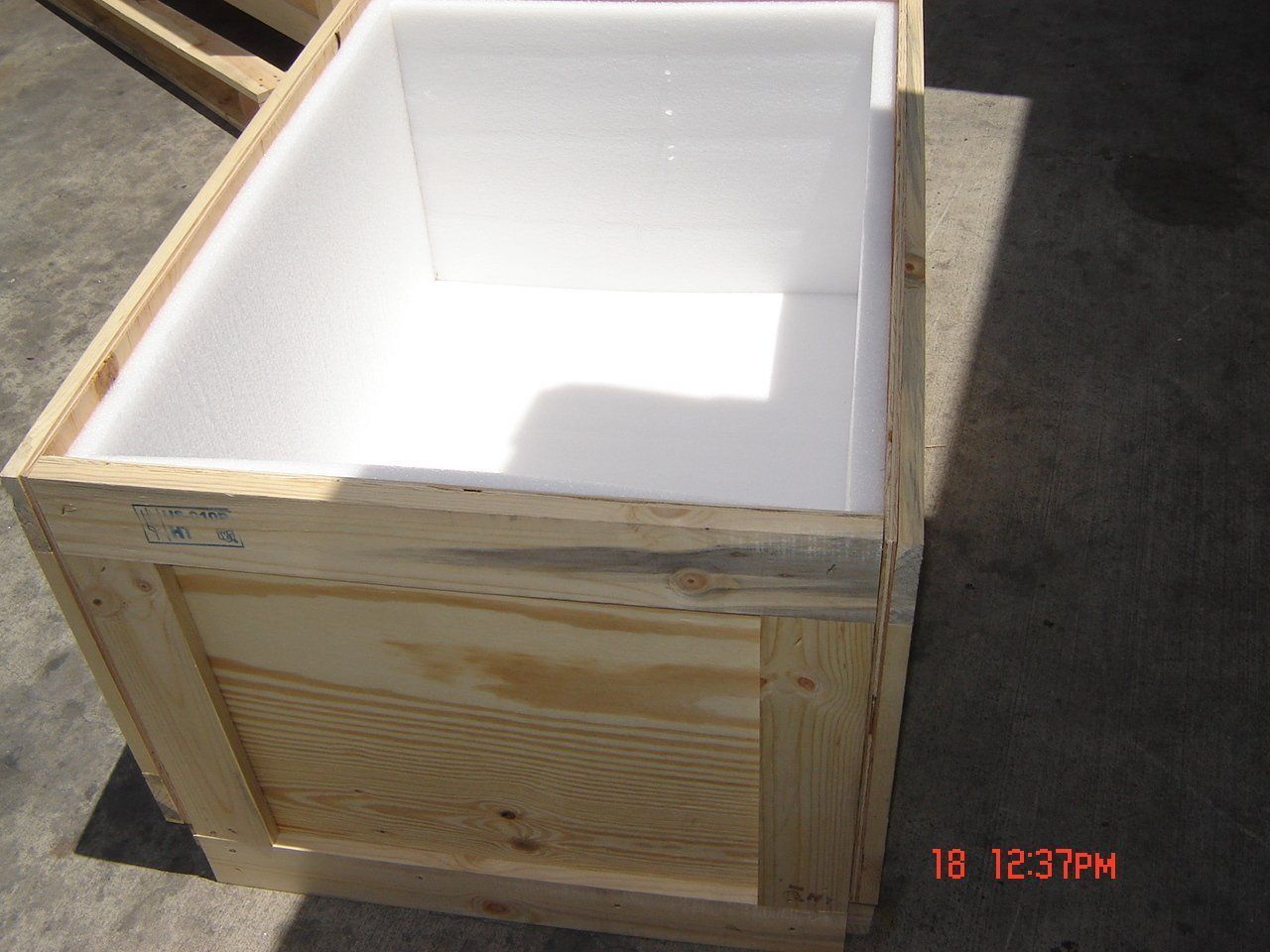 Wooden crate lined with white foam.