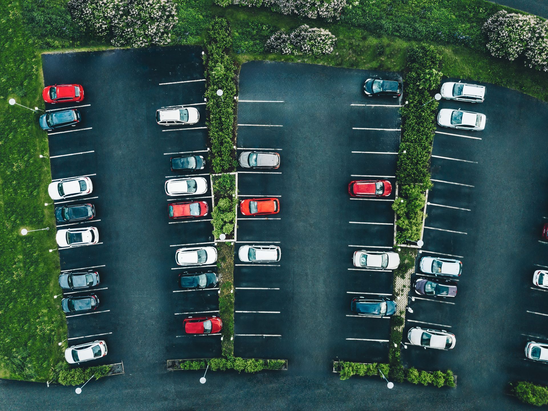 An aerial view of a parking lot filled with cars