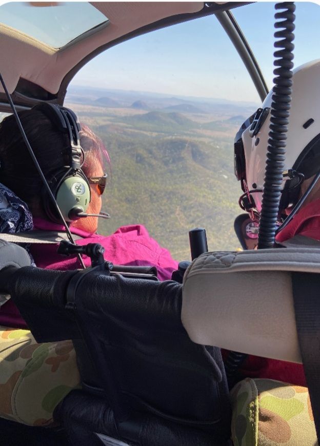 Two People Are Sitting In A Helicopter Looking Out The Window — Wetzler Pty Ltd In Marmor QLD