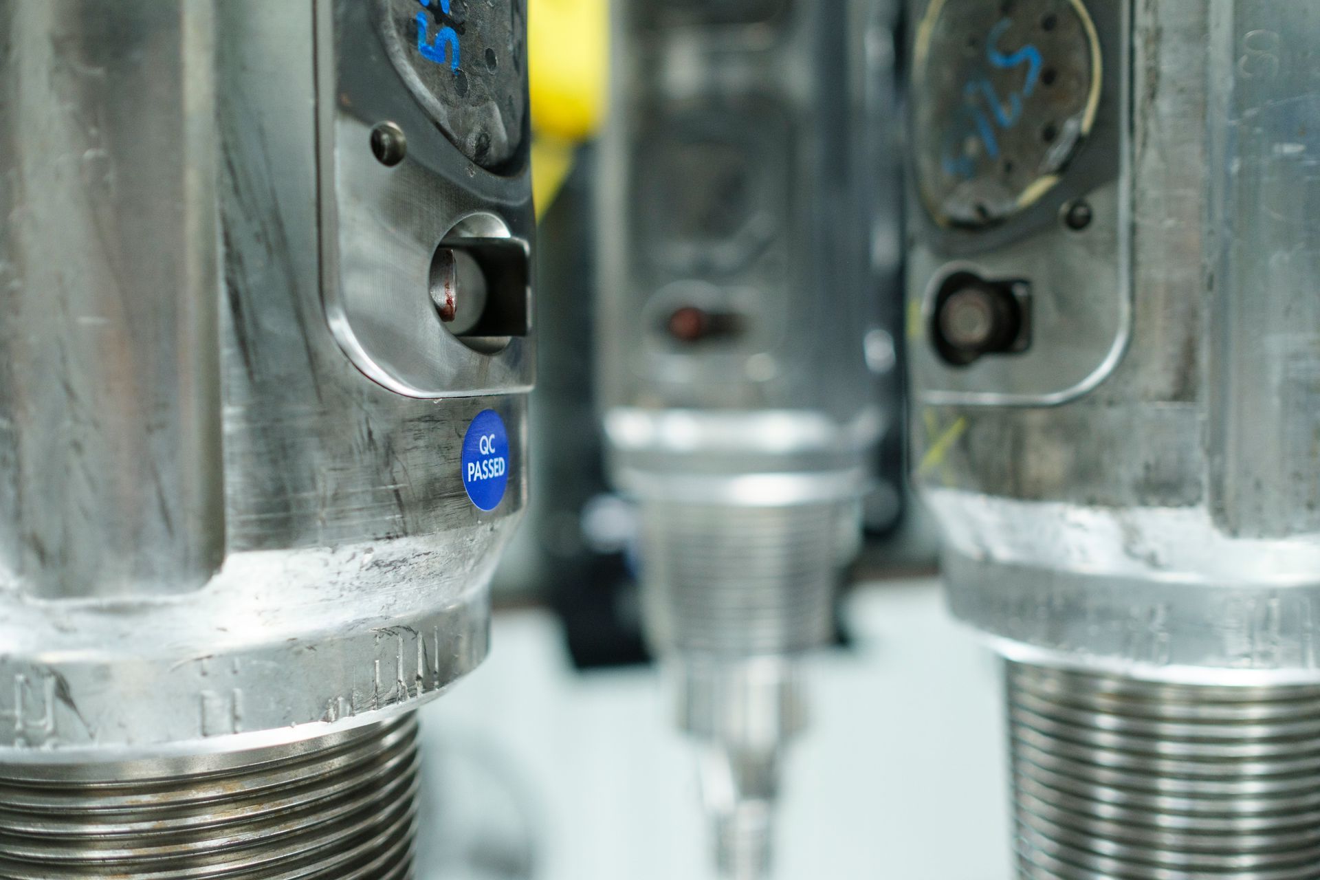 A close up of a metal object with a blue label on it.
