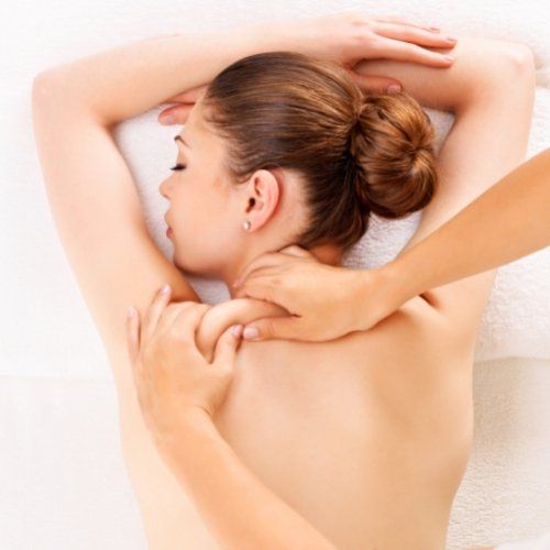 hands massaging a woman's back
