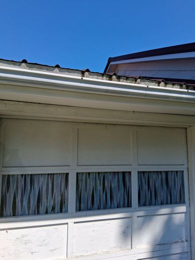 A white garage door with a blue sky in the background