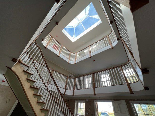 Curved bespoke staircase, custom-designed and expertly crafted by AJ for a stylish and functional architectural feature