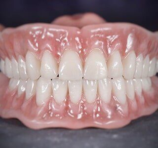 A Close Up of a Person's Teeth With a Full Denture — The Denture Kitchen in Maroochydore, QLD