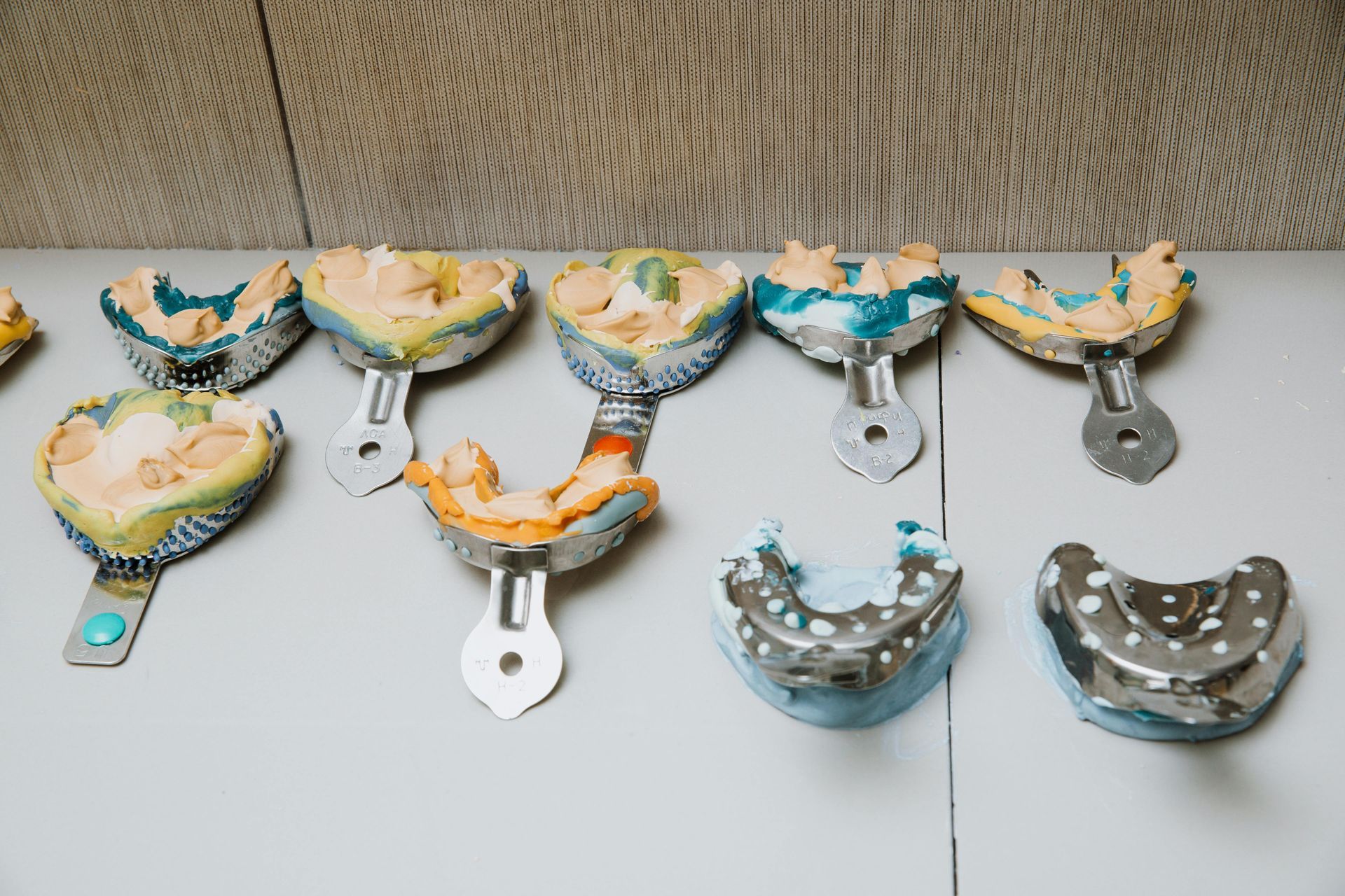 There are many different types of dental impressions on the table. — The Denture Kitchen in Maroochydore, QLD