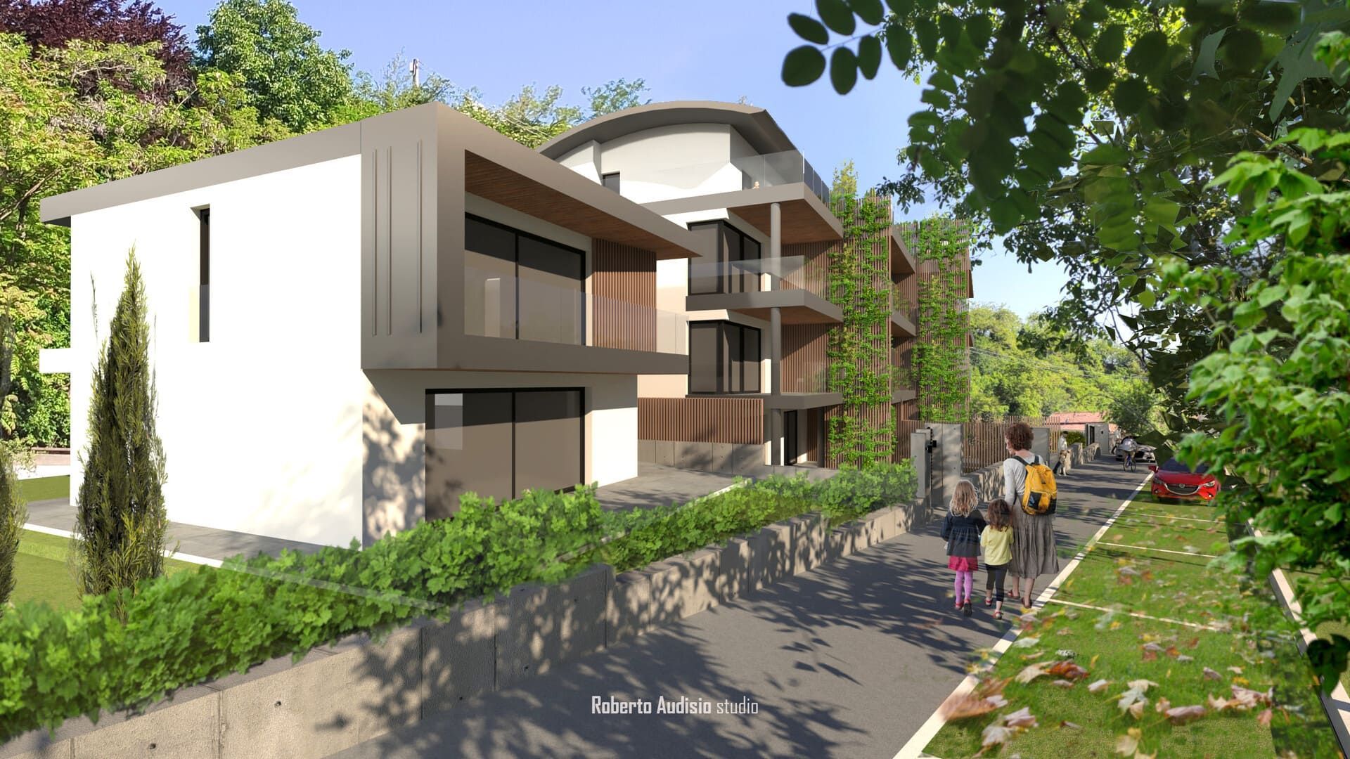 Moderni edifici residenziali con accenti grigio scuro, circondati da alberi e da una strada con gente che cammina.