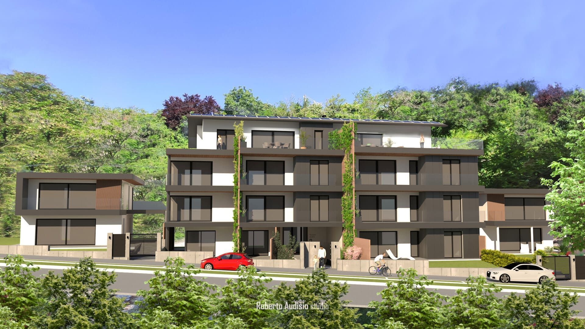 Moderno complesso residenziale a più piani con facciata scura, dettagli verdi e auto parcheggiate davanti.