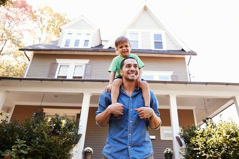Father and Son Outside Their House — Financing in Buford, GA