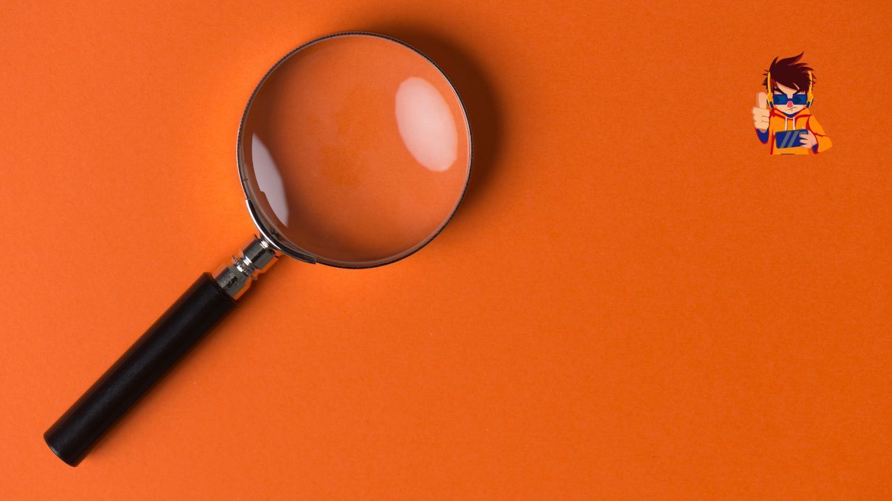 A magnifying glass is sitting on an orange surface.