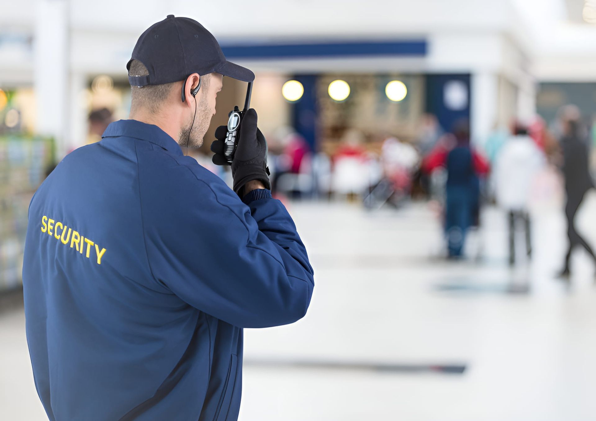 A Security Guard is Talking on a Walkie Talkie — CTE Systems In Hallidays Point, NSW