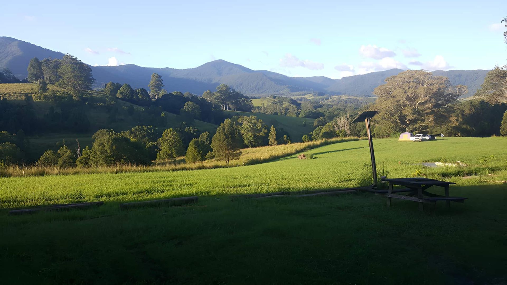 A Grassy Field With a Parked Car — CTE Systems In Hallidays Point, NSW