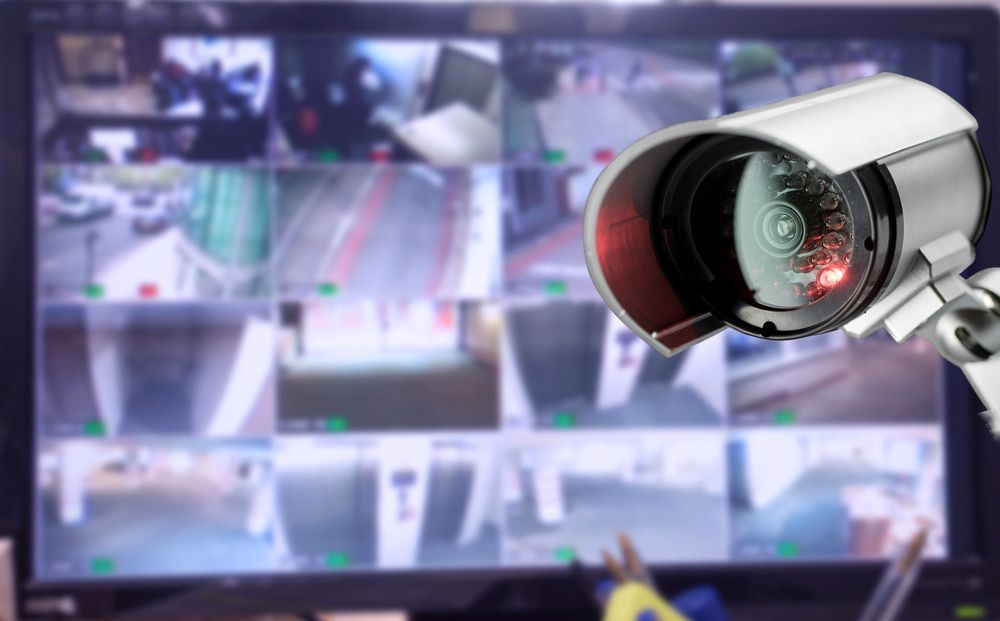 A Security Camera is Sitting in Front of a Computer Monitor — CTE Systems In Hallidays Point, NSW