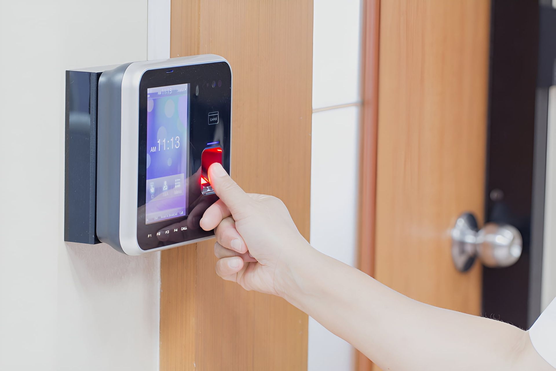 A Person is Using a Fingerprint Scanner to Open a Door — CTE Systems In Hallidays Point, NSW
