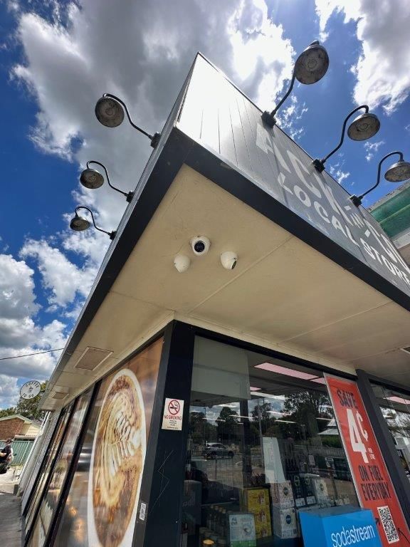 A Man is Installing a Security Camera — CTE Systems In Old Bar, NSW