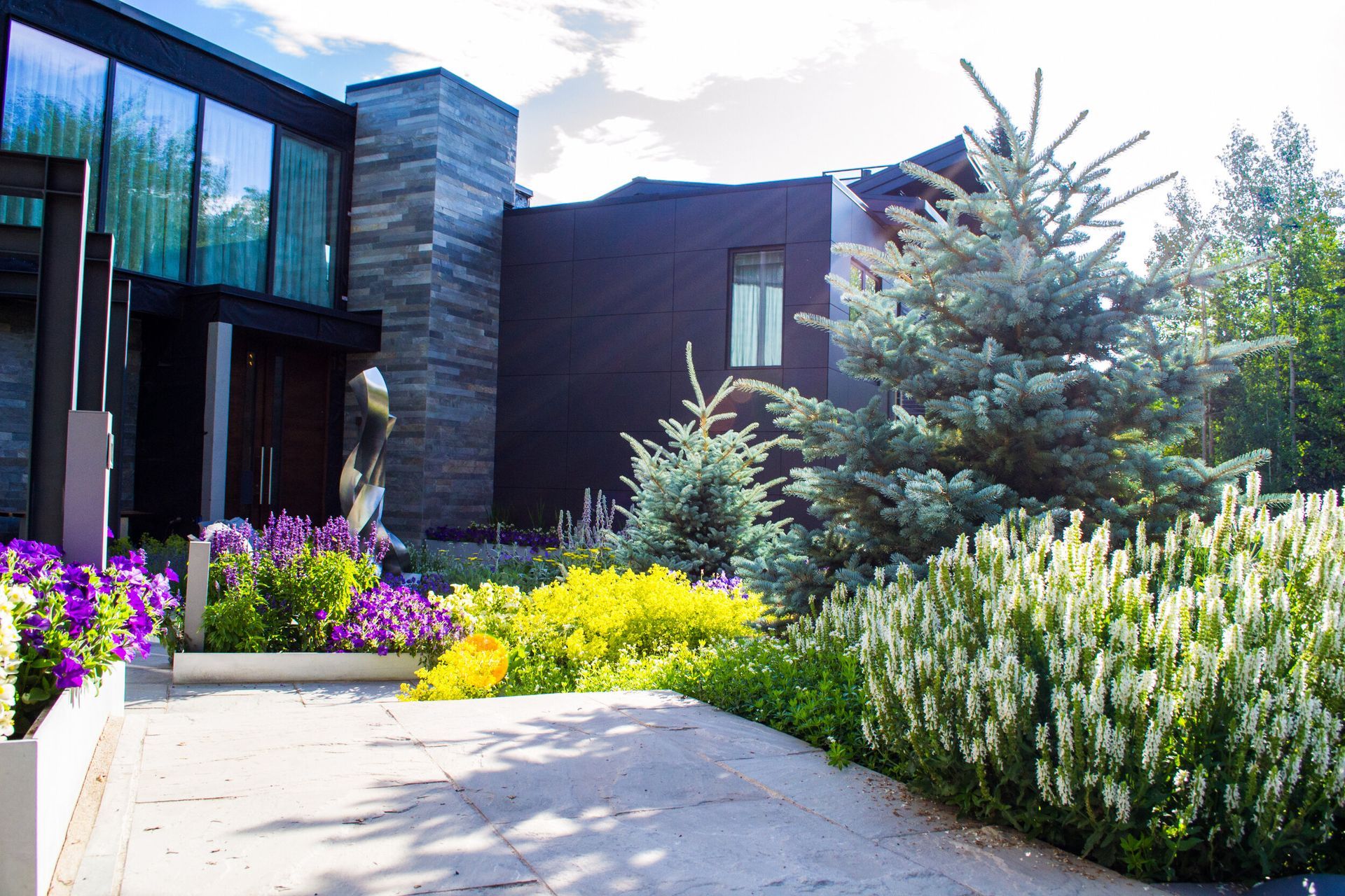 Large House Surrounded by Trees and Flowers — Berthoud, CO — Rocky Mountain Environmental Construction