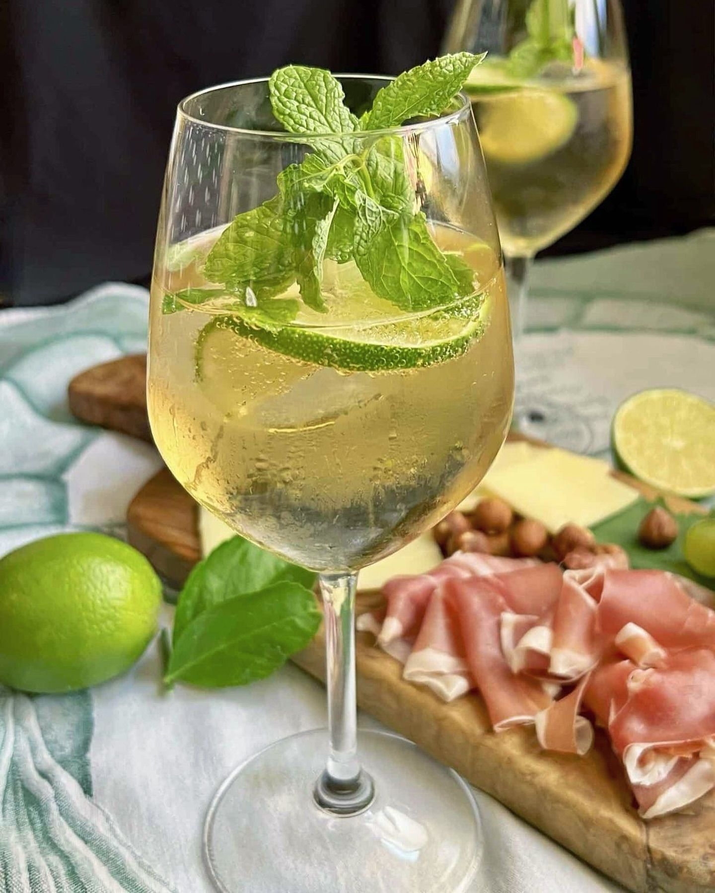 Un primo piano di un bicchiere di vino con un drink dentro, posto su un tavolo.