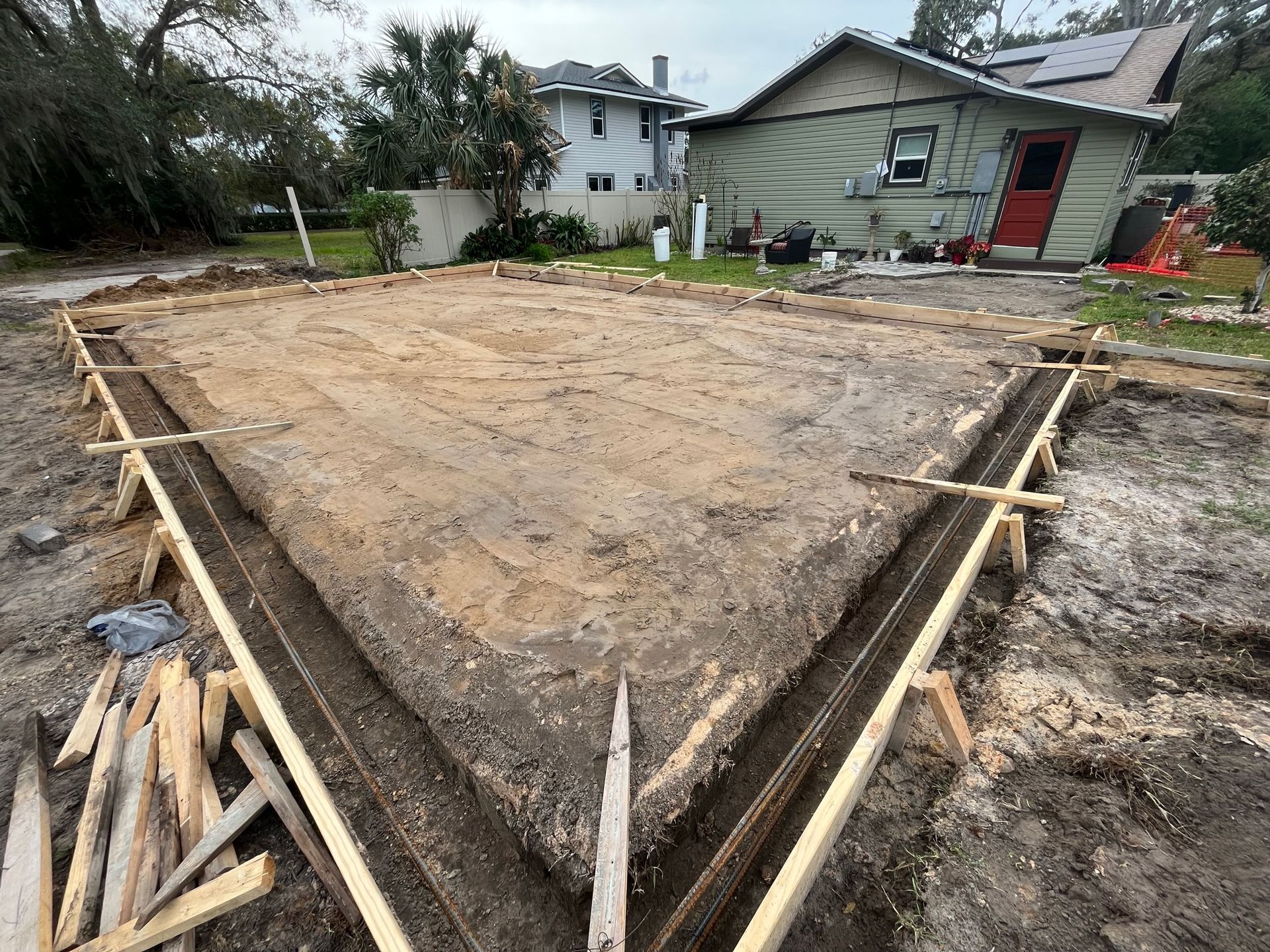 A house is being built in the middle of a dirt field.