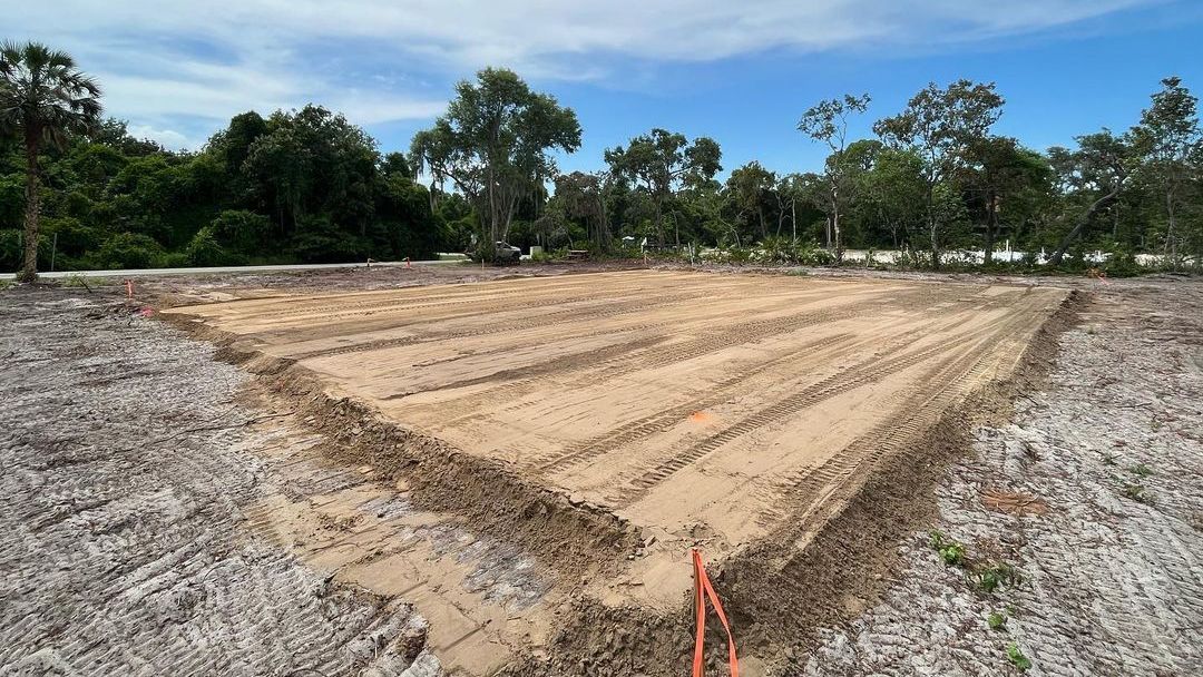 The graded lot was cleared by Samuel Site Service in Florida after hurricane cleanup. The level dirt