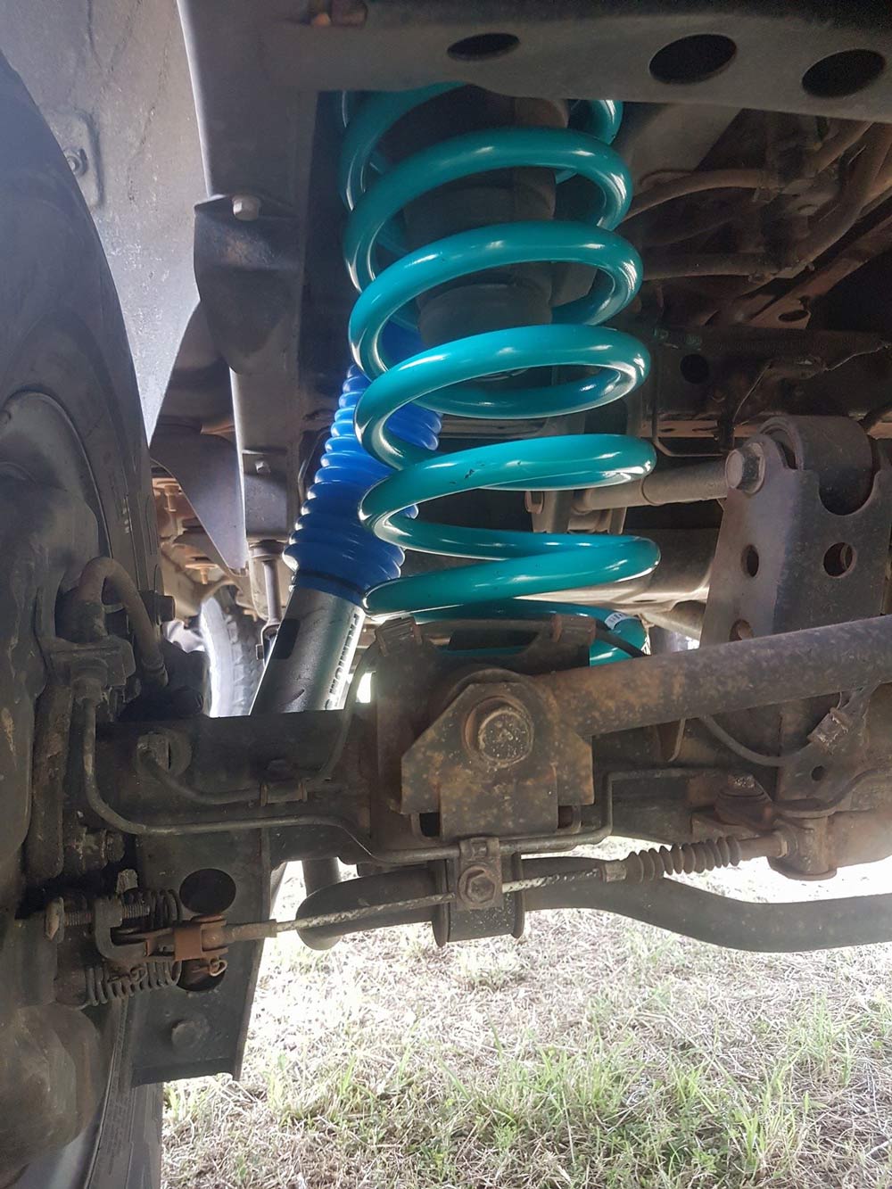 A Close Up Of A Shock Absorber On A Car — Airlie Beach Exhaust and Mechanical In Cannonvale, QLD