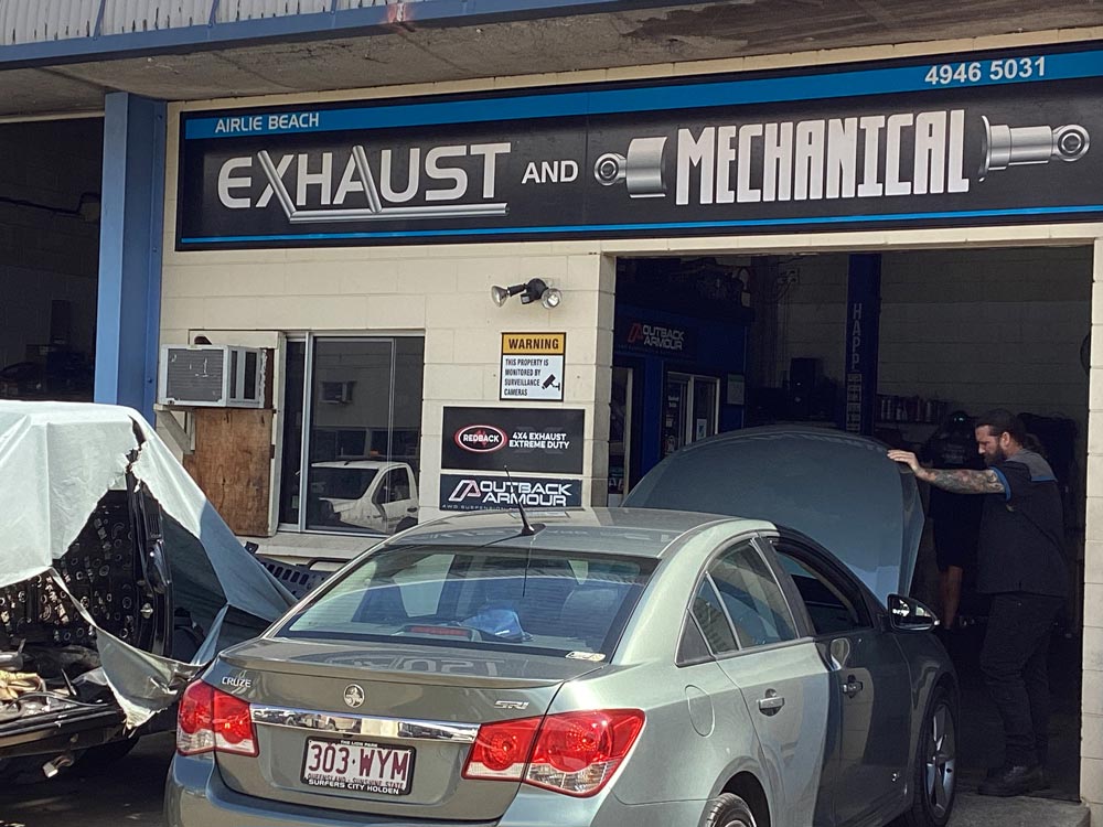 Mechanic Repairing The Car Engine — Airlie Beach Exhaust and Mechanical In Cannonvale, QLD