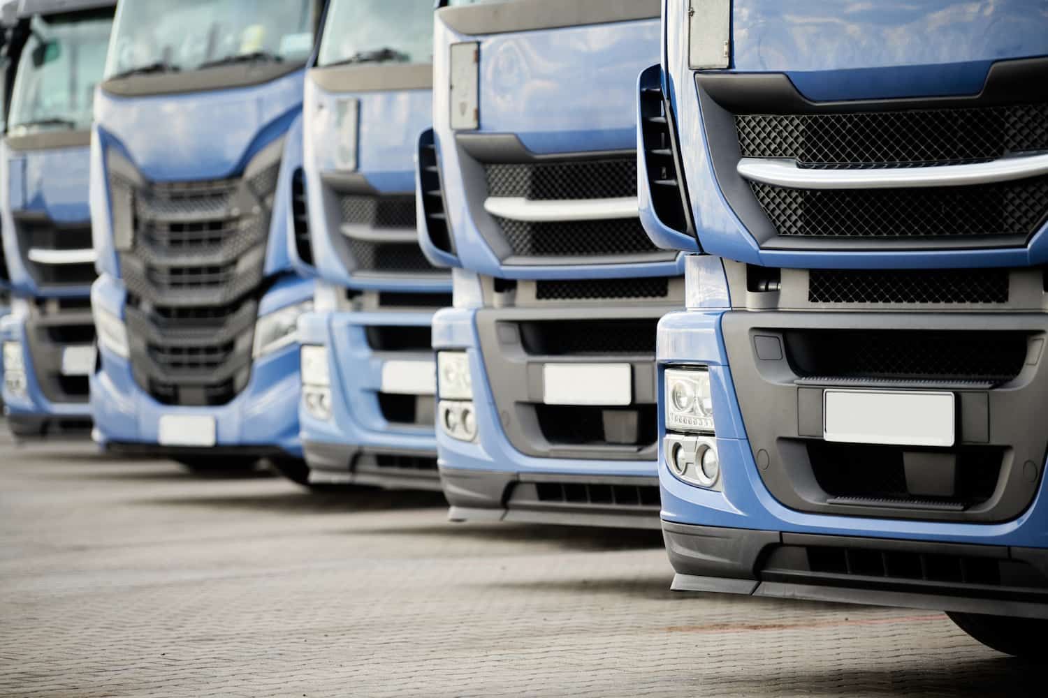 A Row of Blue Semi Trucks Parked in a Parking Lot — Airlie Beach Exhaust and Mechanical In Whitsundays, QLD