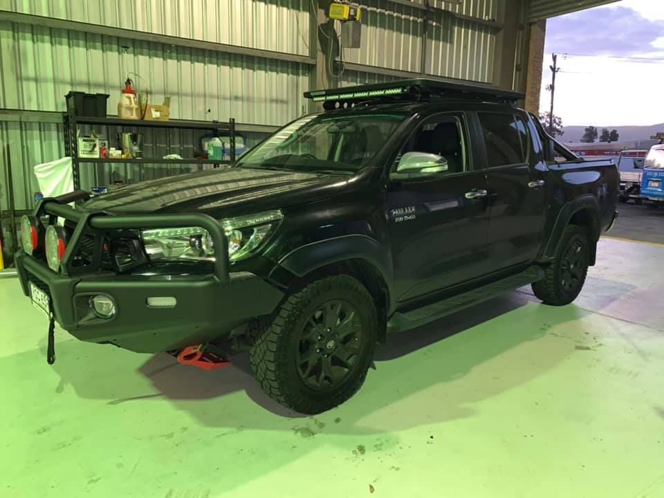 Black Toyota Hilux Truck in a Garage; Has a Roof Rack — D.A.G Automotive in Unanderra, NSW