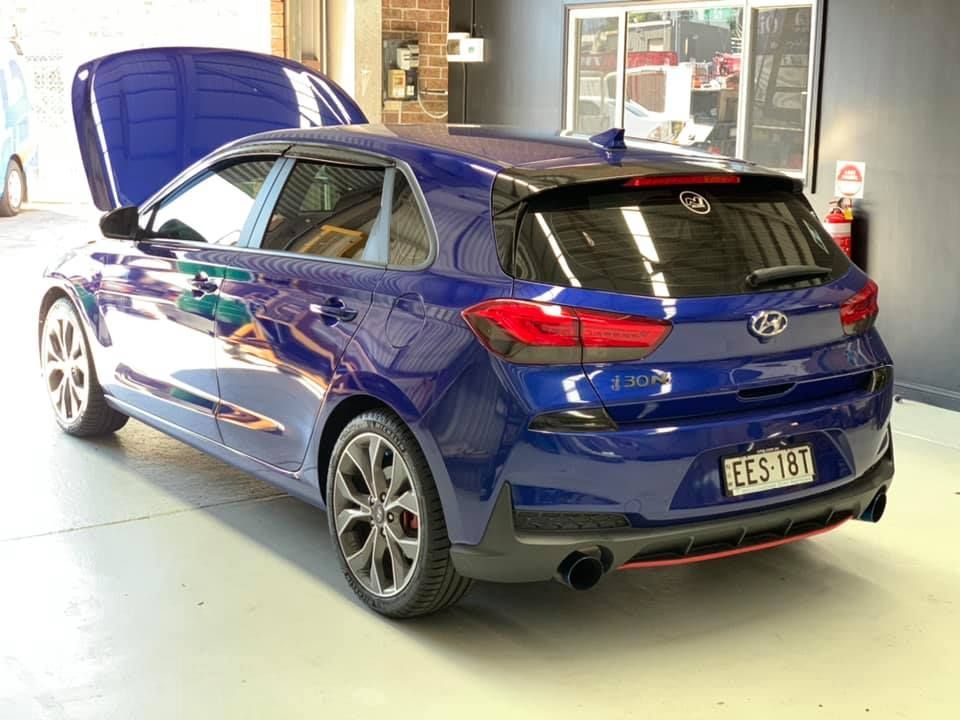 Blue Hyundai i30 N hatchback with hood open in a garage — D.A.G Automotive in Unanderra, NSW