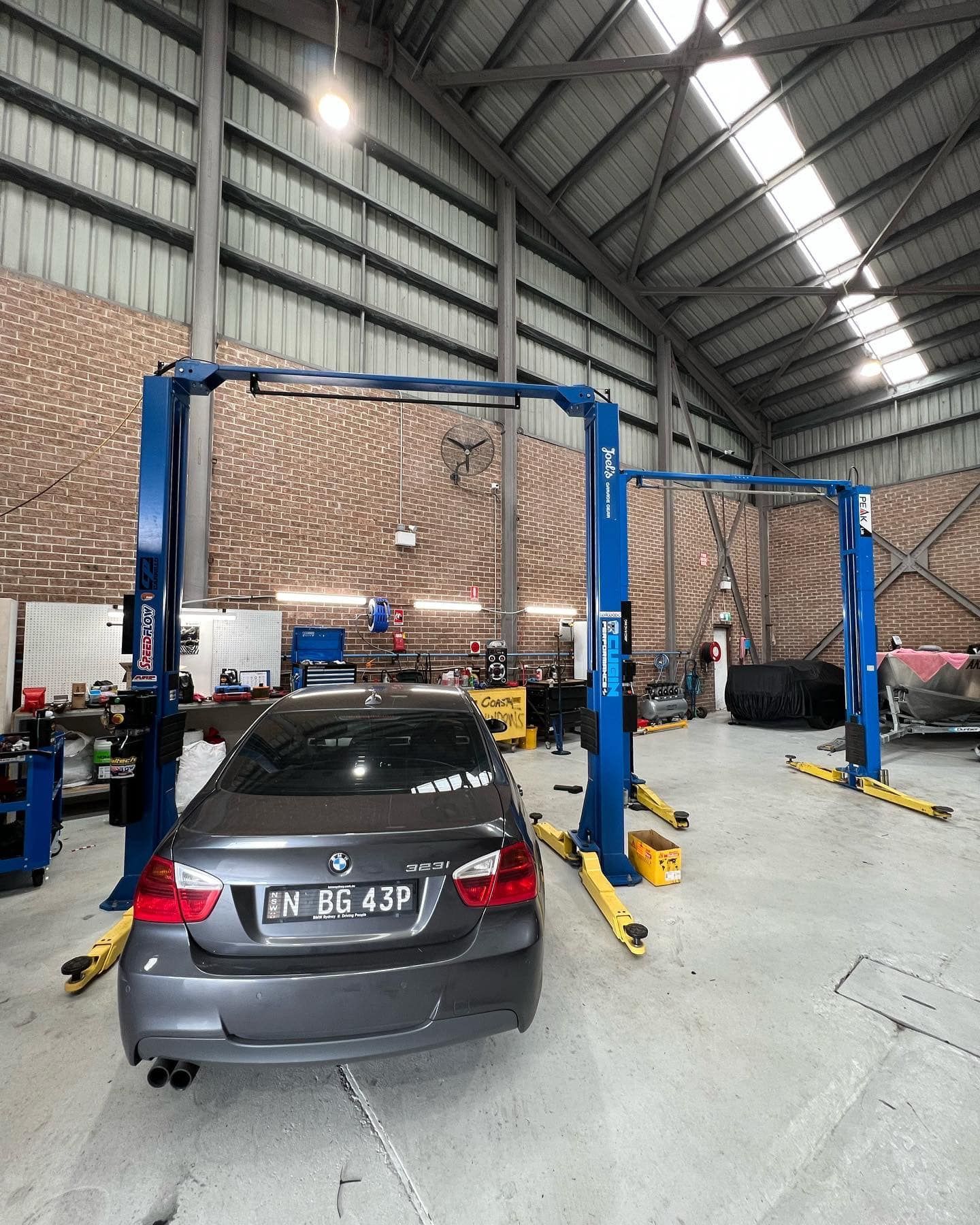 Gray Car on a Lift Inside a Mechanic's Workshop — D.A.G Automotive in Shellharbour, NSW