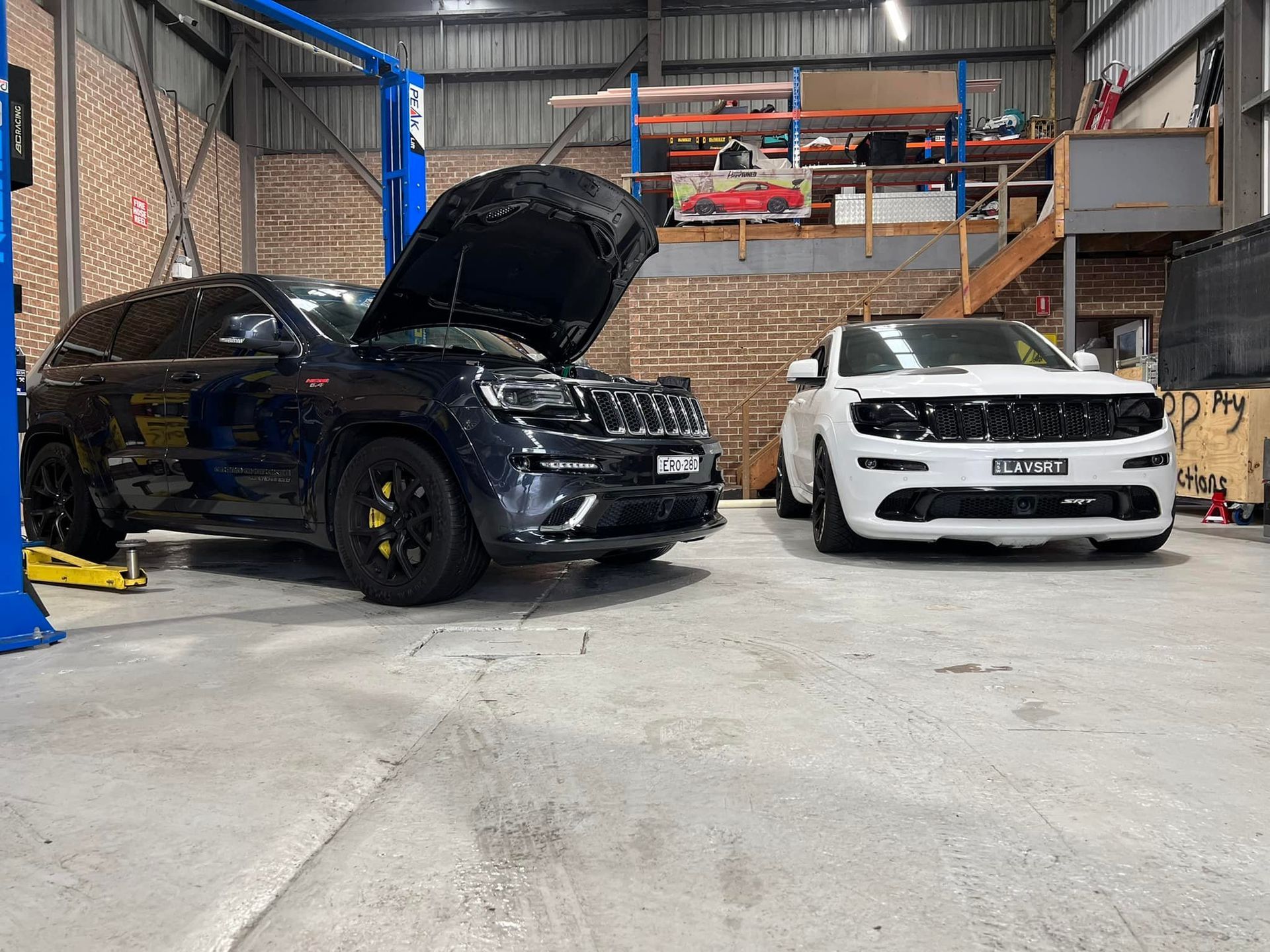 Two Jeep Grand Cherokees in a Garage — D.A.G Automotive in Wollongong, NSW