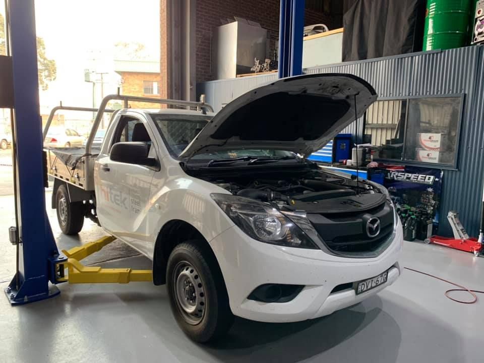 White Mazda Pickup Truck With Hood Open — D.A.G Automotive in Unanderra, NSW