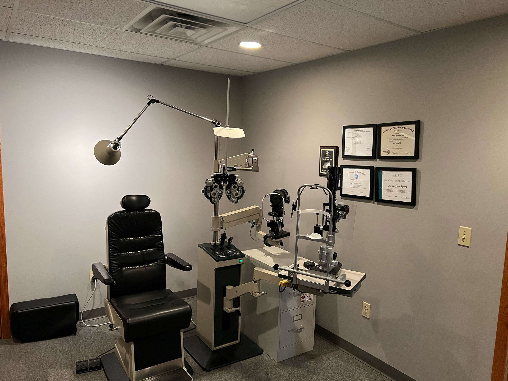An ophthalmologist 's office with a chair and equipment