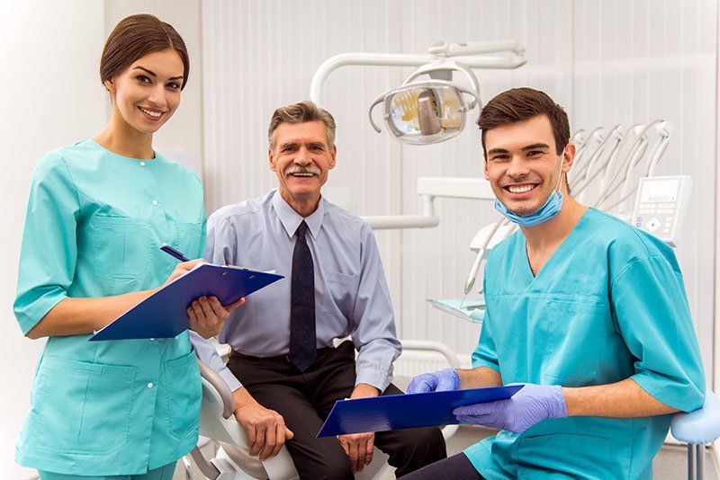 friendly dentist with a senior patient