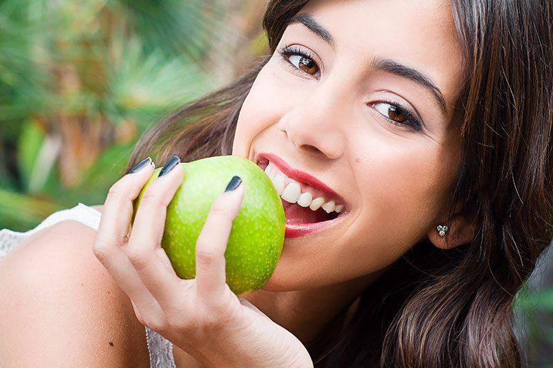 girl with apple smiling