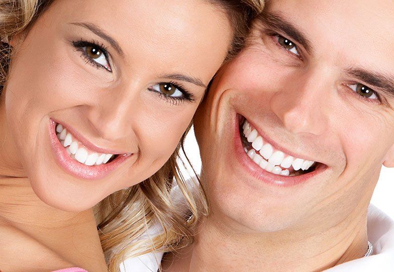 young couple smiling with beautiful teeth