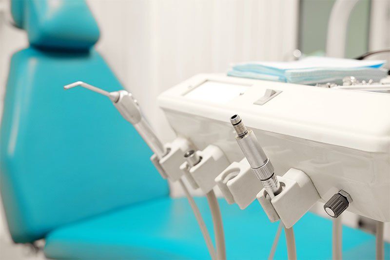 dentist equipment with chair in background